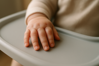 close-up of a baby hand touching the tray, or detail of the high chair material